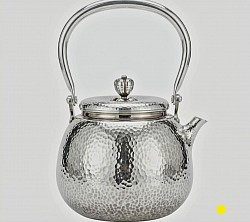 Hand-Hammered sterling silver teapot with arched handle £5000 order number 555. This Hand-Hammered sterling silver teapot with arched handle features an attractive decorative knob
